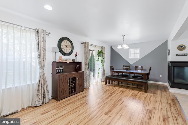 interior space featuring light hardwood / wood-style flooring and a notable chandelier