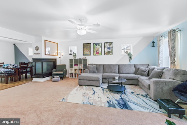 living room with a healthy amount of sunlight, carpet flooring, and ceiling fan