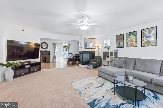 carpeted living room featuring ceiling fan