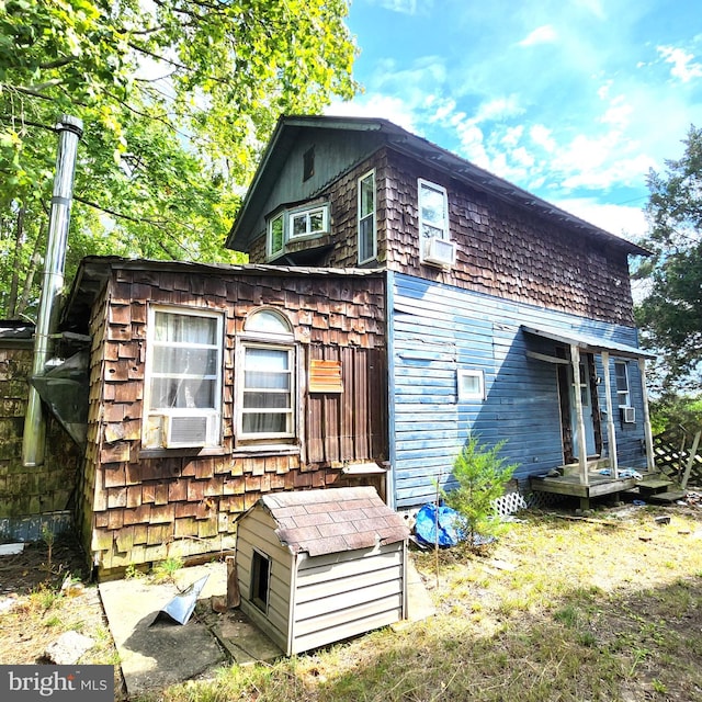 view of property exterior with cooling unit and a deck