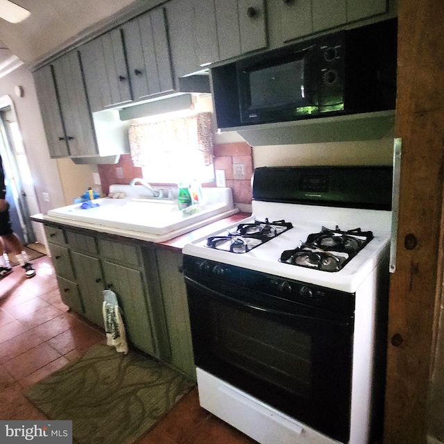 kitchen featuring green cabinetry, sink, and white gas range oven