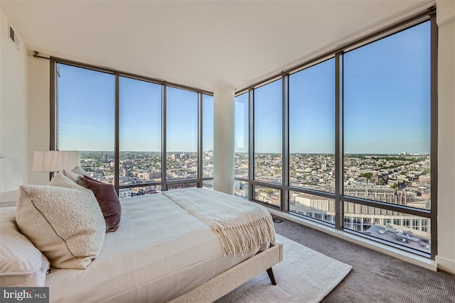 bedroom featuring multiple windows, floor to ceiling windows, and carpet floors