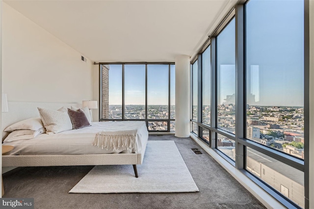 carpeted bedroom featuring multiple windows and a wall of windows