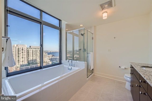 full bathroom with tile patterned flooring, separate shower and tub, vanity, and toilet