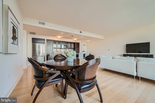 dining space featuring light wood-type flooring