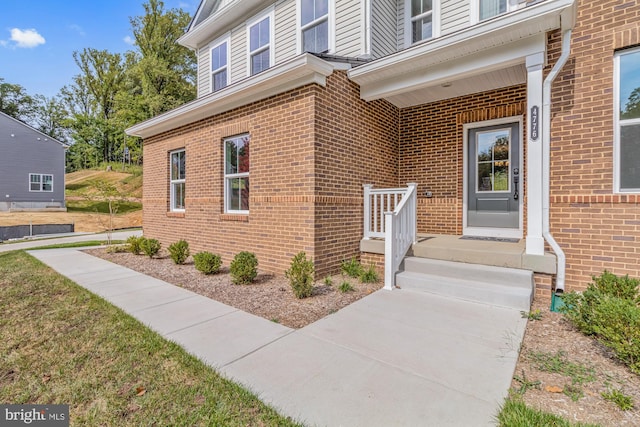 view of exterior entry with a porch