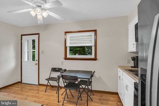 dining room with ceiling fan and light hardwood / wood-style floors