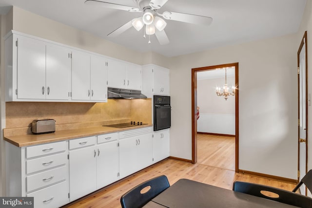 kitchen with ceiling fan with notable chandelier, light wood-type flooring, white cabinetry, and black appliances