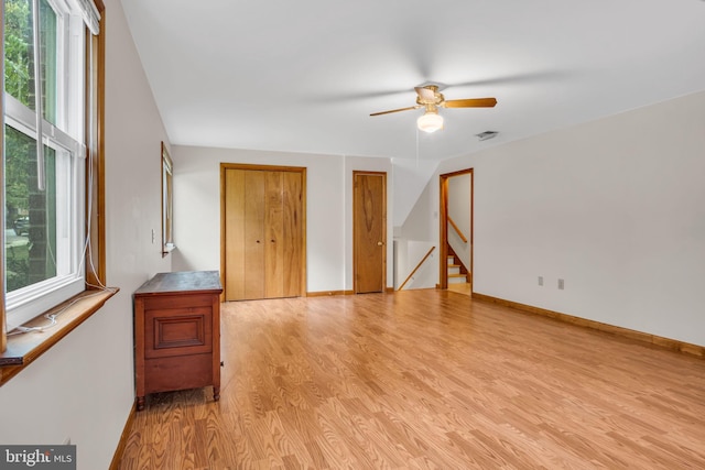 empty room with ceiling fan and light wood-type flooring