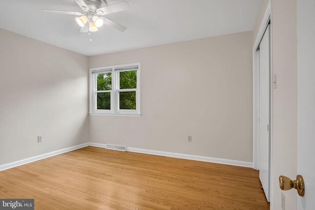 unfurnished bedroom with ceiling fan and light wood-type flooring