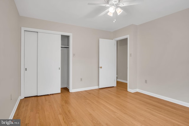 unfurnished bedroom with ceiling fan, light wood-type flooring, and a closet