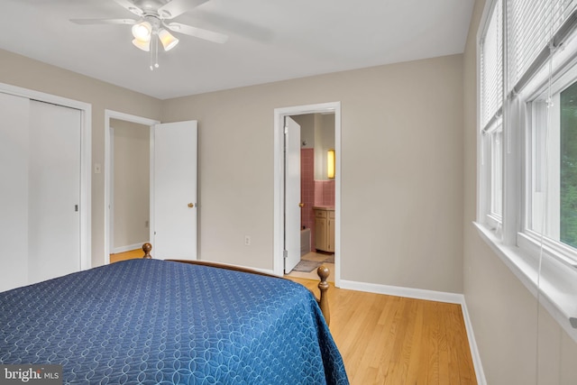 unfurnished bedroom featuring ceiling fan, a closet, connected bathroom, and wood-type flooring