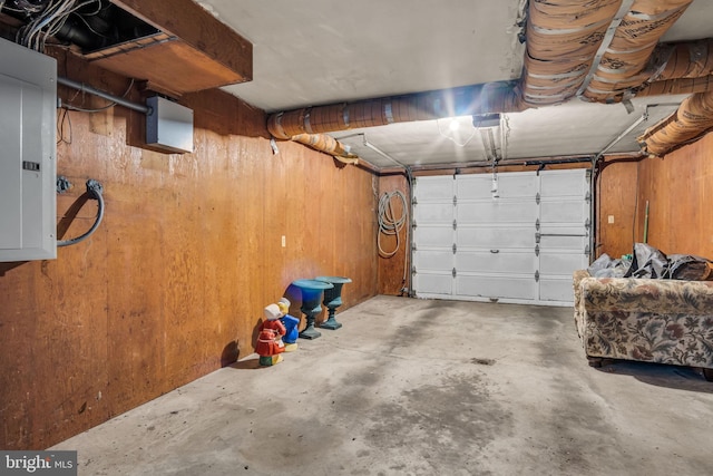 garage featuring wooden walls and electric panel