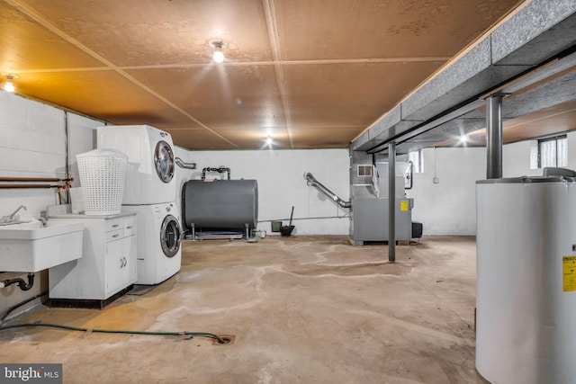 basement with heating unit, water heater, sink, and stacked washer and clothes dryer