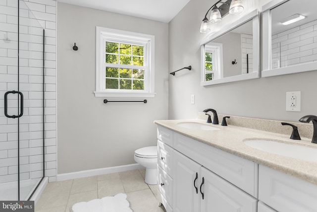 bathroom with a shower with shower door, plenty of natural light, vanity, and toilet