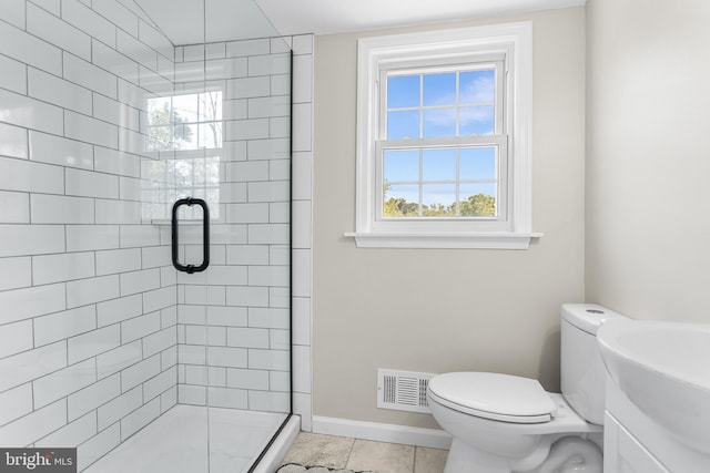 bathroom featuring walk in shower, vanity, tile patterned flooring, and toilet