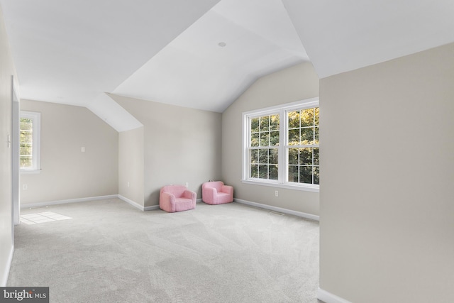 playroom with lofted ceiling and light colored carpet