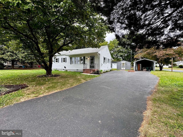 1315 Lexington St, Salisbury, MD 21804 - view of front of home featuring crawl space, a detached carport, a front yard, and aphalt driveway