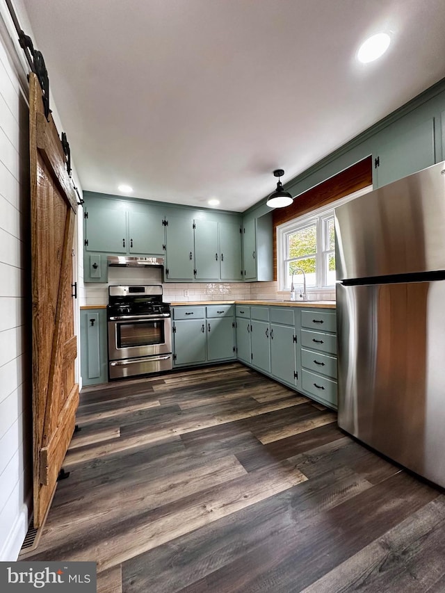 1315 Lexington St, Salisbury, MD 21804 - kitchen featuring under cabinet range hood, dark wood-style flooring, stainless steel appliances, and light countertops