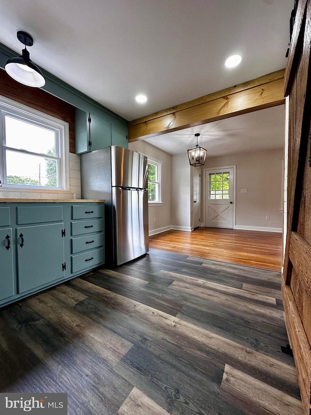 1315 Lexington St, Salisbury, MD 21804 - kitchen with dark wood-type flooring, baseboards, an inviting chandelier, and freestanding refrigerator