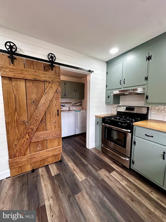 1315 Lexington St, Salisbury, MD 21804 - kitchen with stainless steel range with gas stovetop, under cabinet range hood, washing machine and clothes dryer, dark wood-style floors, and a barn door