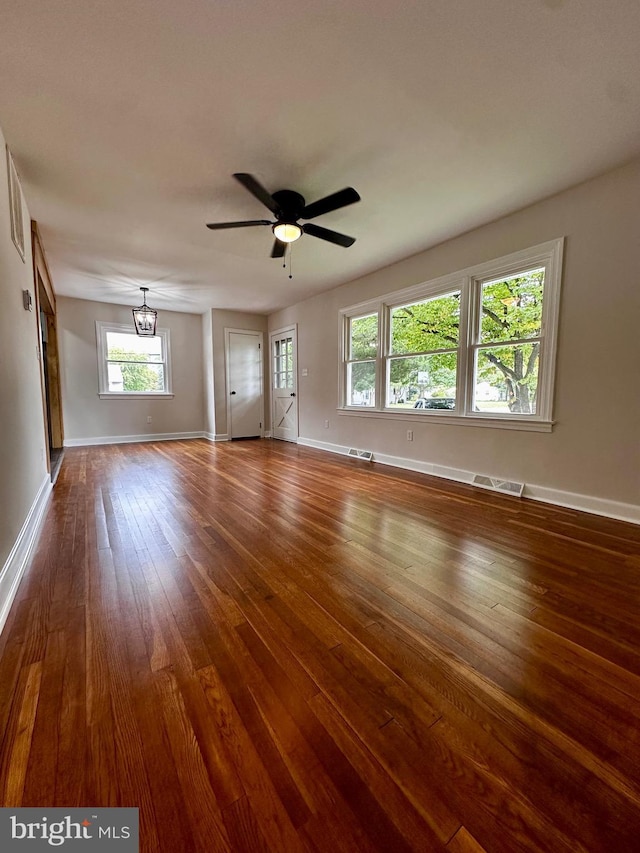 1315 Lexington St, Salisbury, MD 21804 - unfurnished room with baseboards, visible vents, ceiling fan with notable chandelier, and dark wood finished floors