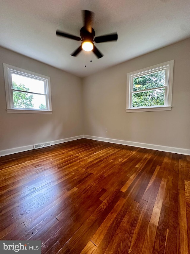1315 Lexington St, Salisbury, MD 21804 - empty room with baseboards, visible vents, dark wood-style flooring, and a healthy amount of sunlight