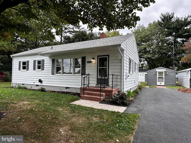 1315 Lexington St, Salisbury, MD 21804 - view of front of house with an outdoor structure, driveway, crawl space, a front lawn, and a chimney