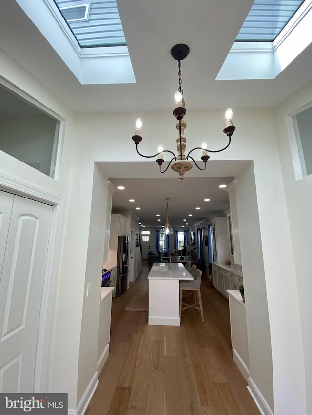 interior space featuring a notable chandelier, sink, and hardwood / wood-style flooring