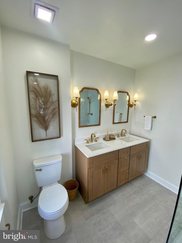 bathroom with tile patterned floors, vanity, and toilet