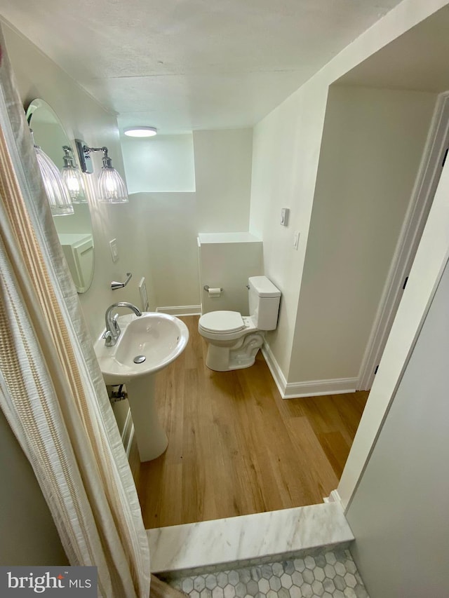 bathroom featuring toilet and hardwood / wood-style flooring