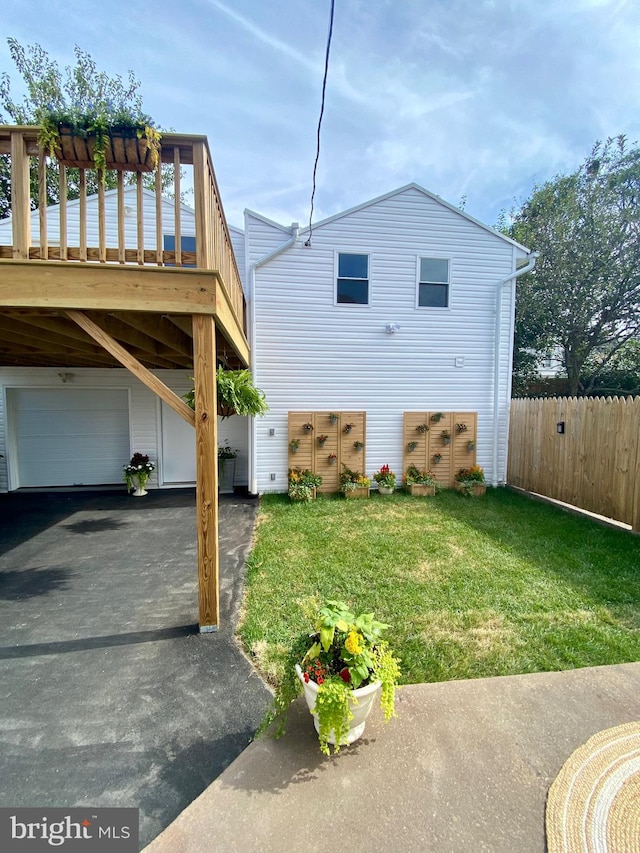 view of side of property with a deck and a lawn