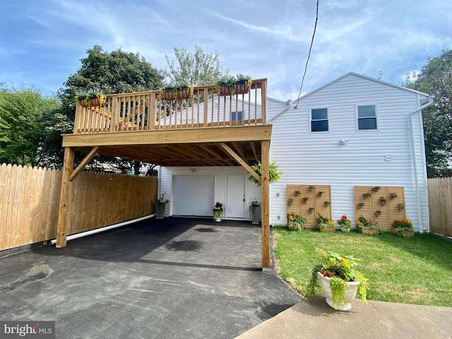 view of front of property with a garage, a wooden deck, and a front lawn