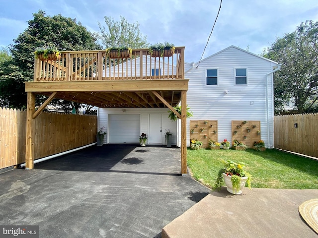 exterior space featuring a garage, a deck, and a front lawn