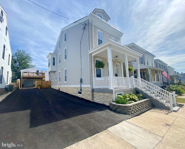 view of front of house with covered porch and central air condition unit