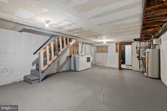 basement featuring washing machine and dryer and gas water heater