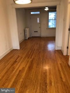 interior space with radiator heating unit and hardwood / wood-style flooring