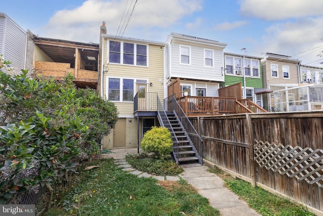 rear view of house with a wooden deck