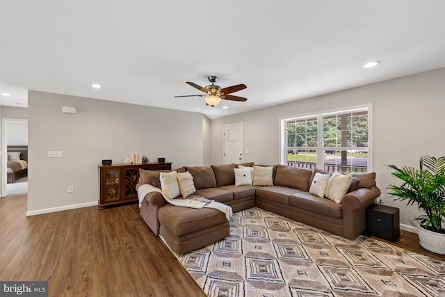 living room featuring ceiling fan and hardwood / wood-style floors