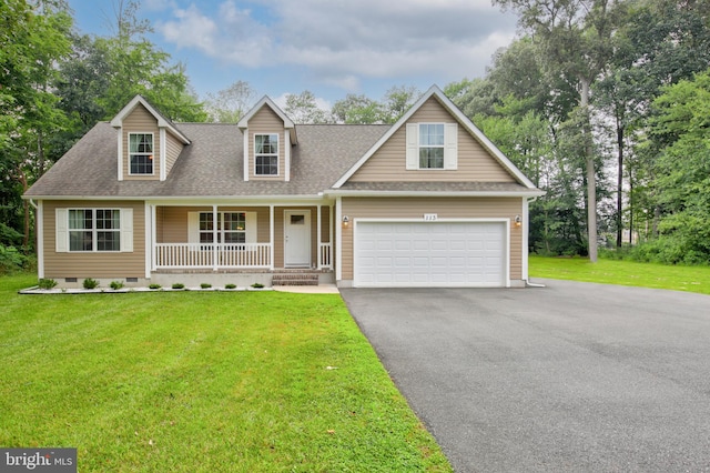 view of front of house with a porch, a garage, and a front yard