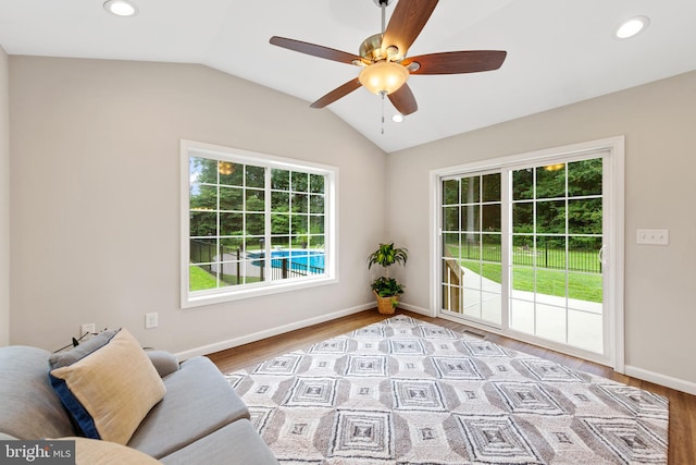 unfurnished room with light hardwood / wood-style floors, lofted ceiling, and ceiling fan