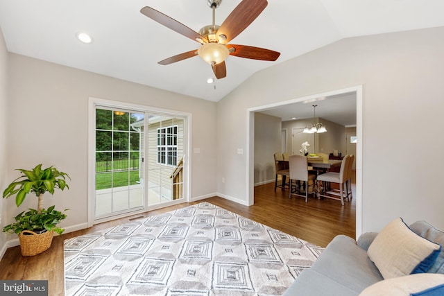 living room with light hardwood / wood-style floors, lofted ceiling, and ceiling fan