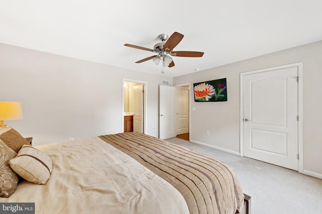 carpeted bedroom with ceiling fan and connected bathroom