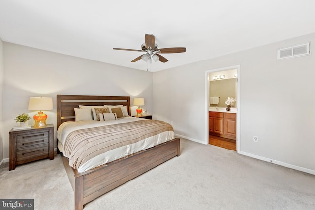 carpeted bedroom featuring ceiling fan and connected bathroom