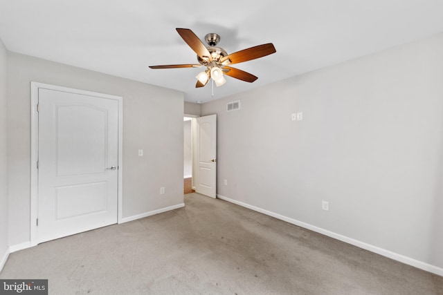 unfurnished bedroom with ceiling fan and light colored carpet