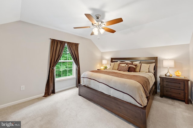 carpeted bedroom featuring lofted ceiling and ceiling fan