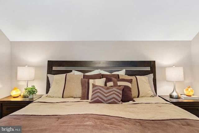 bedroom featuring hardwood / wood-style floors and vaulted ceiling