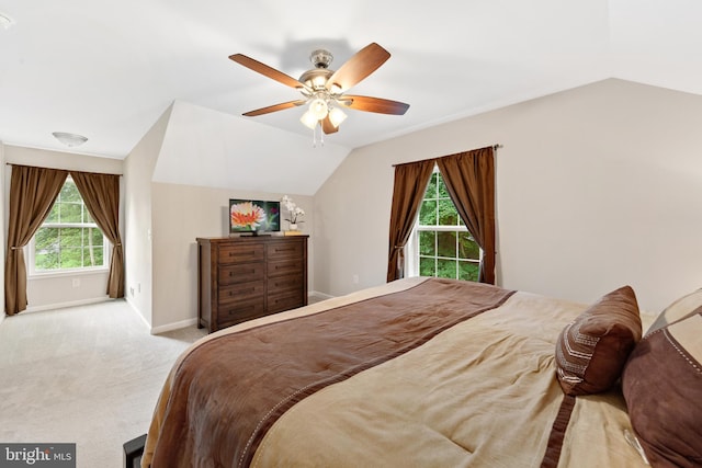 bedroom with ceiling fan, lofted ceiling, and light carpet