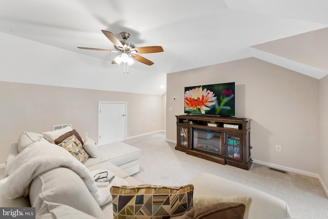 carpeted living room featuring vaulted ceiling and ceiling fan