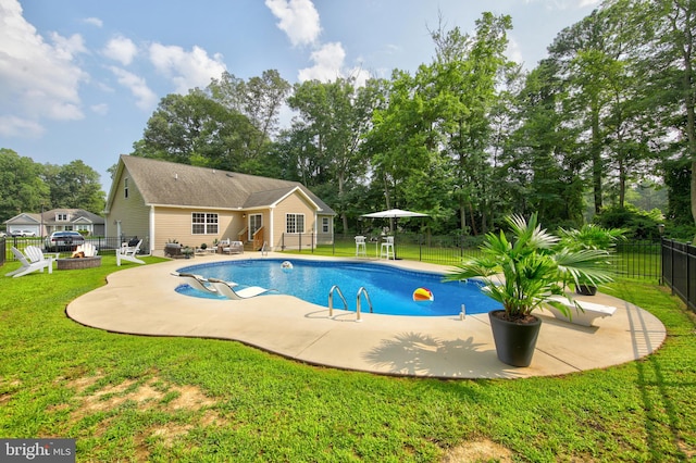 view of swimming pool featuring a yard and a patio area